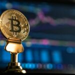 selective focus photo of Bitcoin near monitor